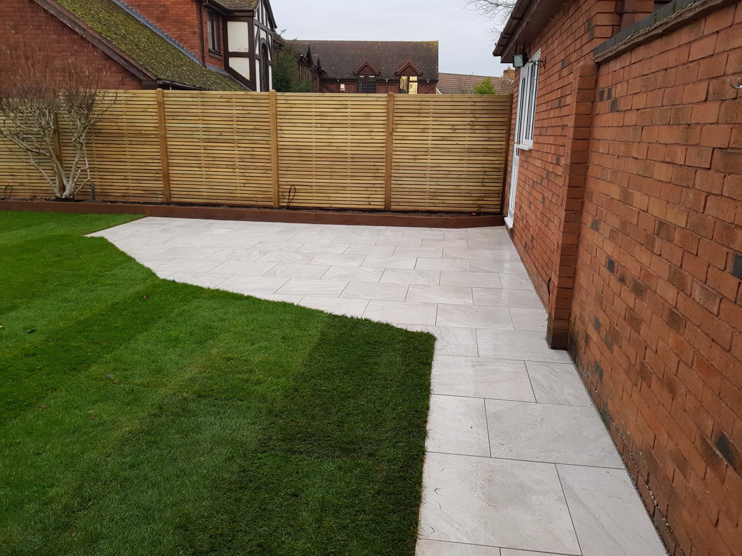 New lawn, porcelaine paving, sleeper borders and fence